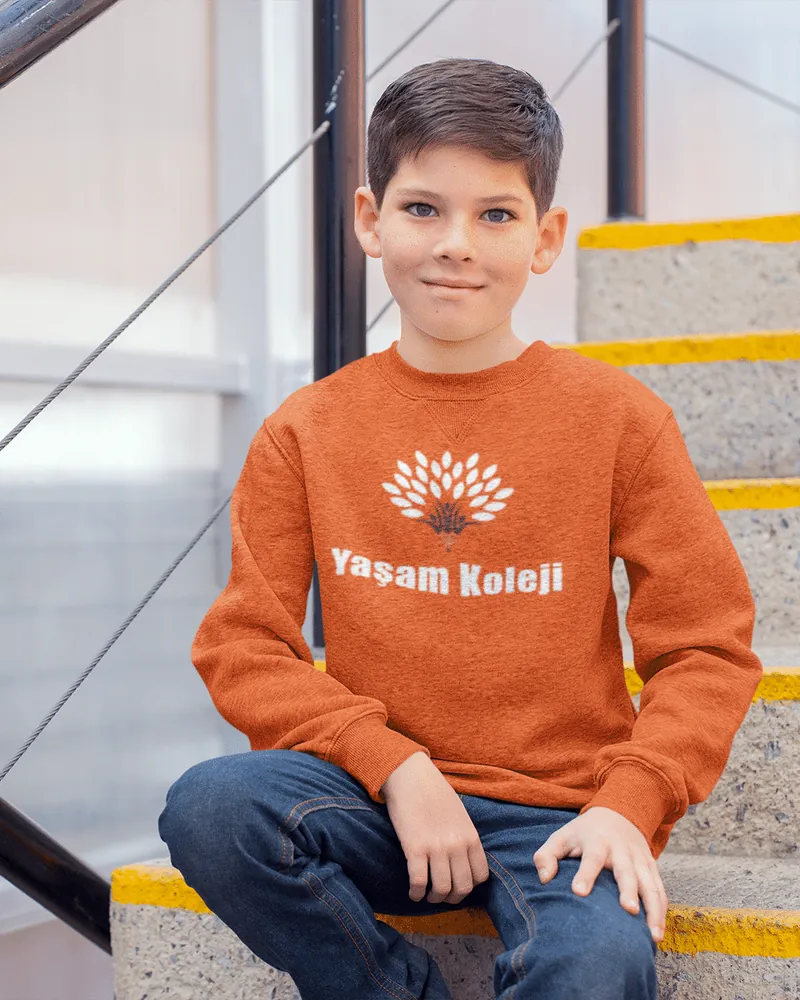 Student wearing a sweatshirt with the school logo