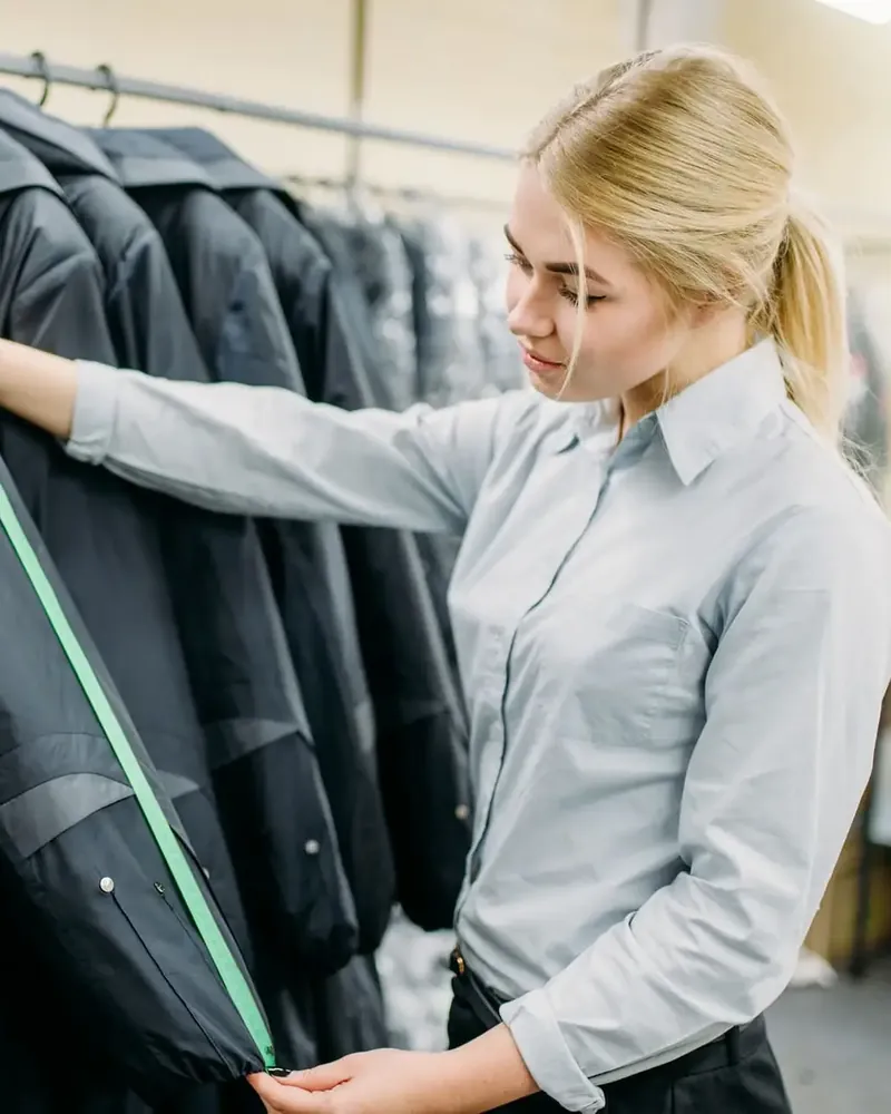 Workwear designer measuring a jacket sleeve
